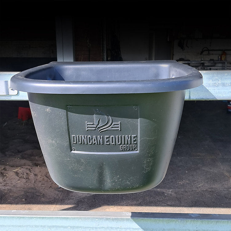 Green plastic tub with 'Duncan Equine Group' logo on a dark background